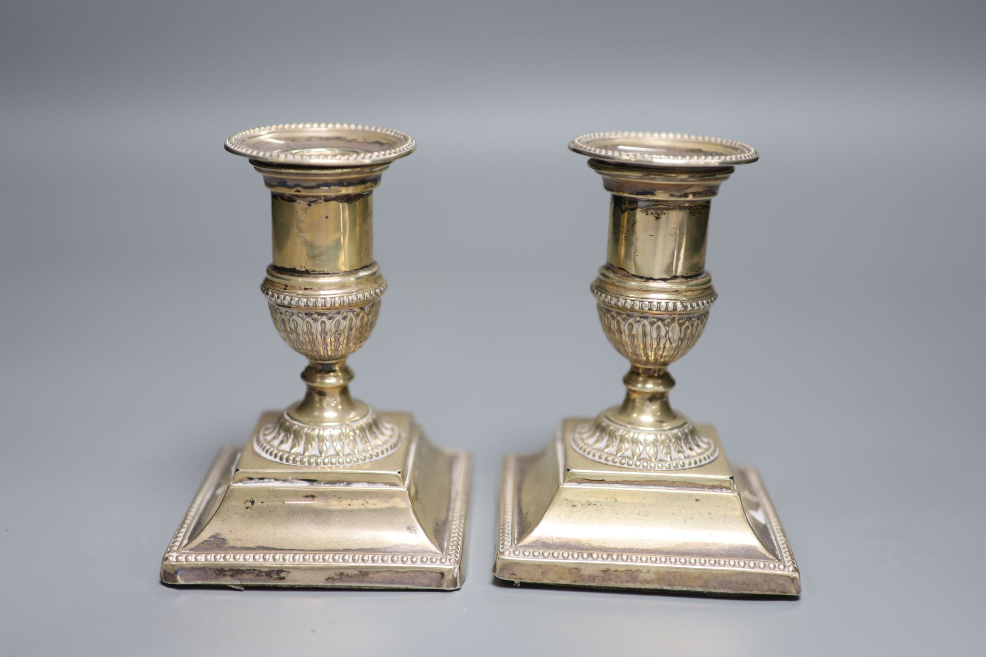 A pair of late Victorian silver dwarf candlesticks, Josiah Williams & Co, London, 1892, 11.1cm, weighted.